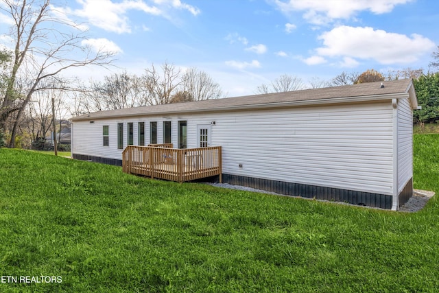 back of house with a wooden deck and a yard