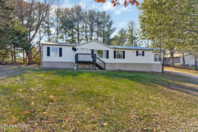 manufactured / mobile home featuring a front lawn