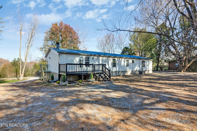 back of house with a wooden deck