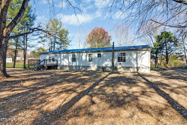 back of property featuring a wooden deck