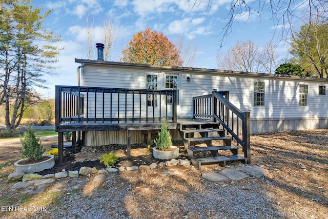 rear view of house with a wooden deck