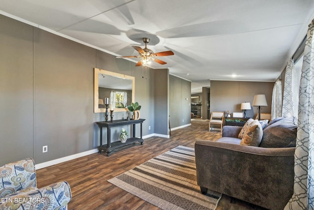 living room with ceiling fan, dark wood-type flooring, lofted ceiling, and ornamental molding