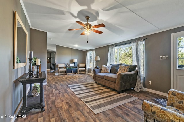 living room featuring a wealth of natural light, crown molding, ceiling fan, and dark wood-type flooring