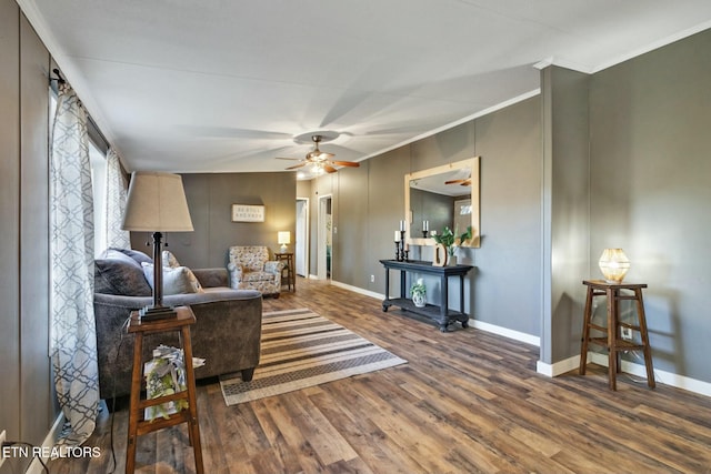 living room featuring hardwood / wood-style flooring, ceiling fan, and ornamental molding