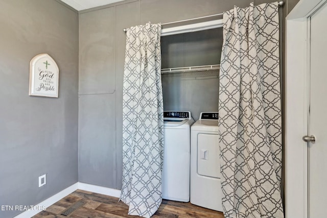 laundry area with dark hardwood / wood-style flooring and washing machine and clothes dryer