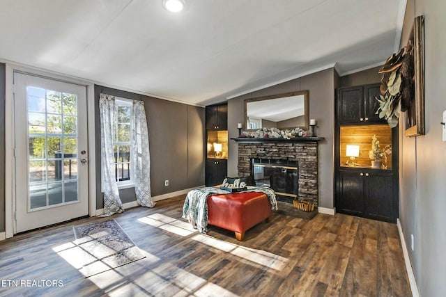 living room with a fireplace, ornamental molding, lofted ceiling, and hardwood / wood-style flooring