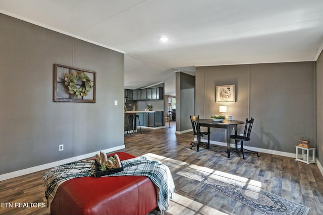 living room featuring ornamental molding, dark hardwood / wood-style floors, and lofted ceiling