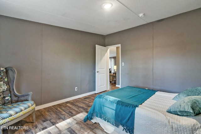 bedroom with dark hardwood / wood-style floors