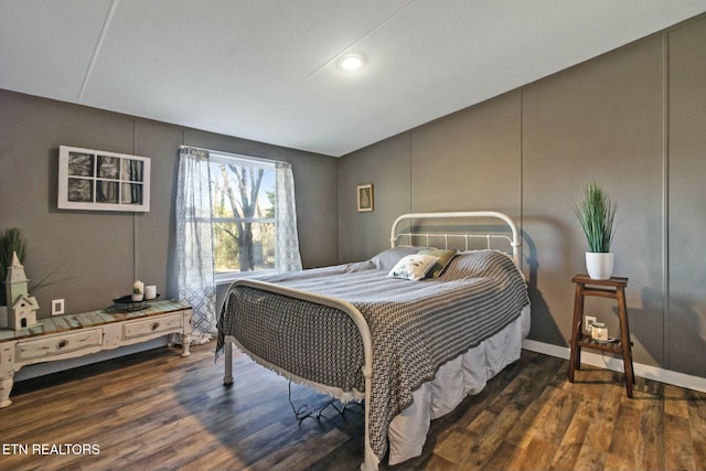 bedroom with dark hardwood / wood-style flooring