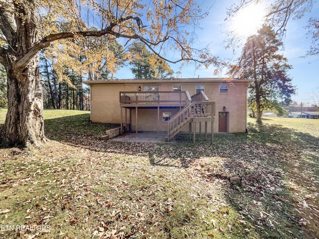 back of house with a lawn and a wooden deck