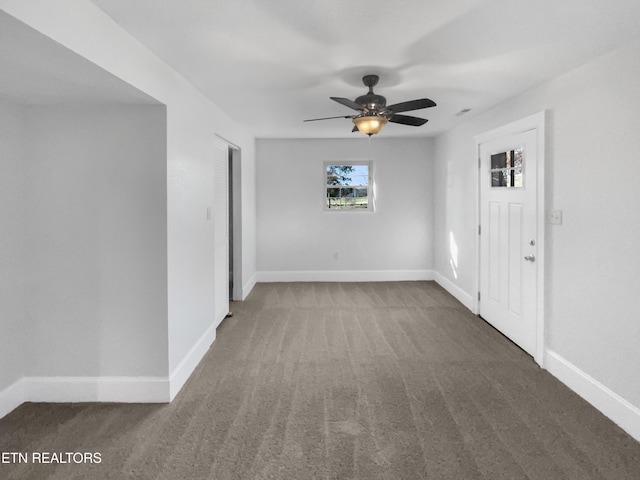 carpeted spare room with ceiling fan