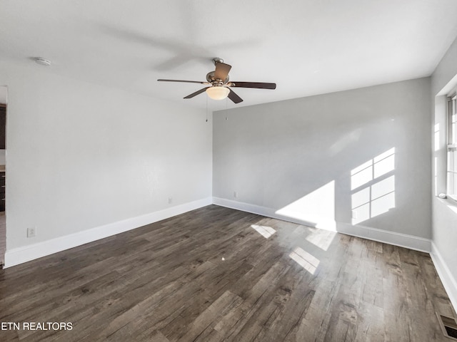 unfurnished room with ceiling fan and dark hardwood / wood-style floors