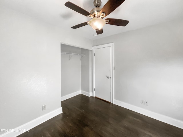 unfurnished bedroom with ceiling fan, dark hardwood / wood-style floors, and a closet