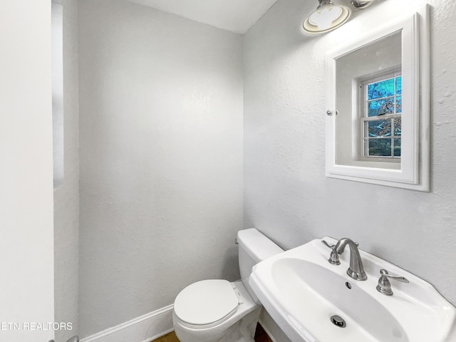 bathroom featuring toilet and sink