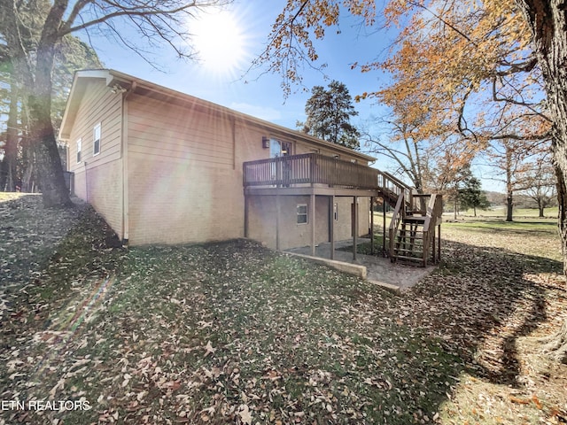 rear view of house with a wooden deck