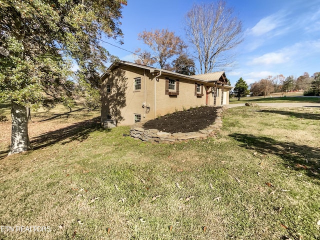 view of side of property with a lawn