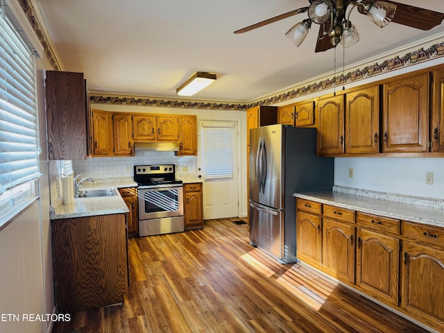 115 Greasy Cove Rd, Cosby, TN 37722 - kitchen featuring stainless steel appliances, under cabinet range hood, brown cabinetry, and a ceiling fan