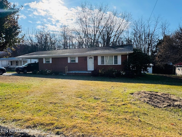 single story home featuring a front yard and a carport