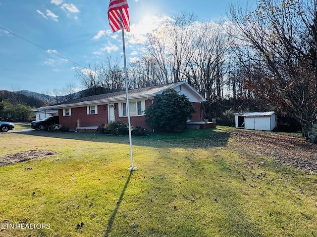 115 Greasy Cove Rd, Cosby, TN 37722 - view of front facade featuring brick siding, a shed, and a front lawn