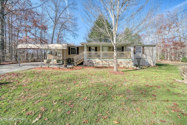 view of front of home with a carport, a porch, and a front lawn