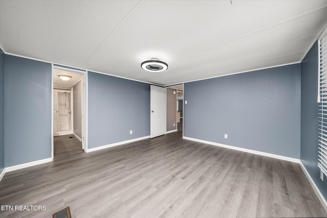 interior space featuring a textured ceiling and hardwood / wood-style flooring