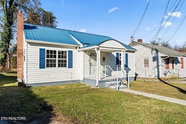 bungalow-style home with a front lawn