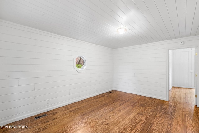 unfurnished room featuring hardwood / wood-style floors and wood ceiling