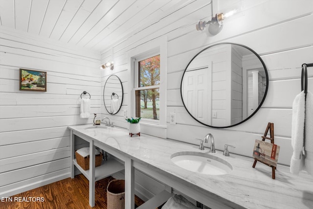 bathroom featuring hardwood / wood-style flooring, vanity, wooden ceiling, and wooden walls