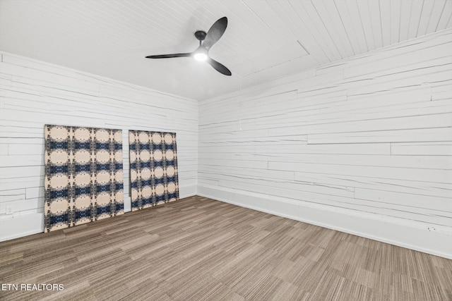 empty room with hardwood / wood-style floors and ceiling fan