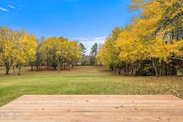 view of yard featuring a wooden deck and a rural view