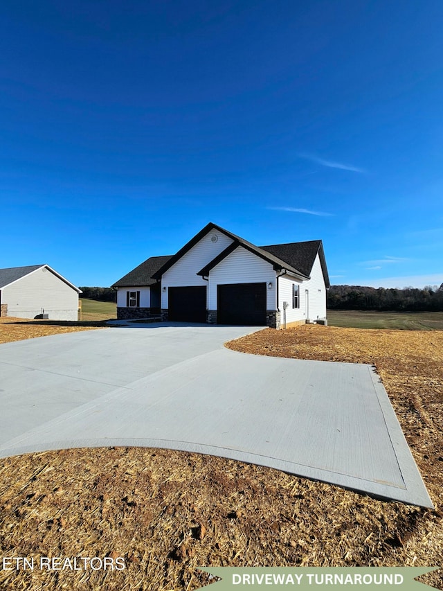 view of front of house featuring driveway and a garage