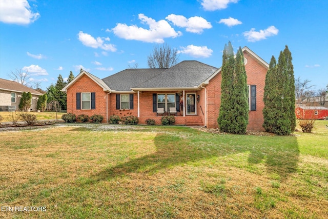 ranch-style house featuring a front yard and covered porch