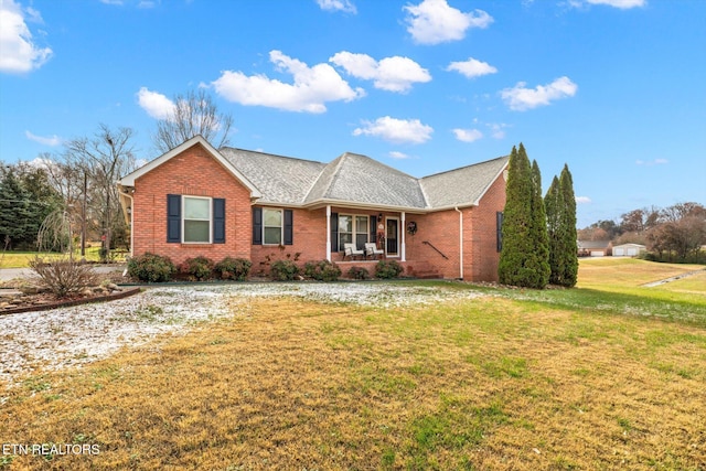 single story home featuring a front yard and covered porch