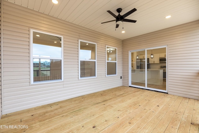 unfurnished sunroom featuring ceiling fan and wooden ceiling