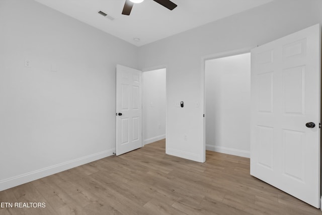 unfurnished bedroom with ceiling fan and light wood-type flooring