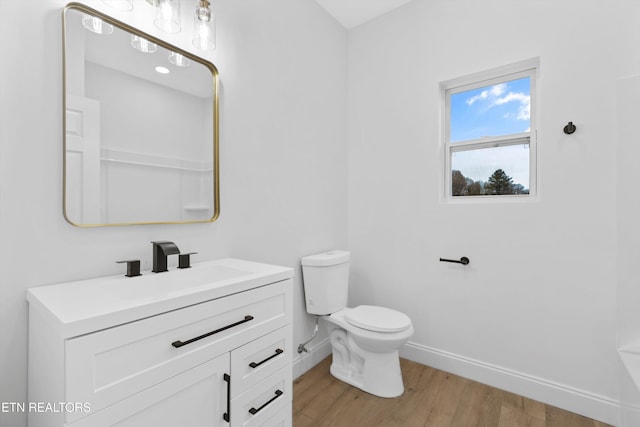 bathroom with vanity, toilet, and wood-type flooring