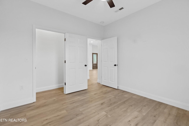 unfurnished bedroom with ceiling fan and light hardwood / wood-style flooring