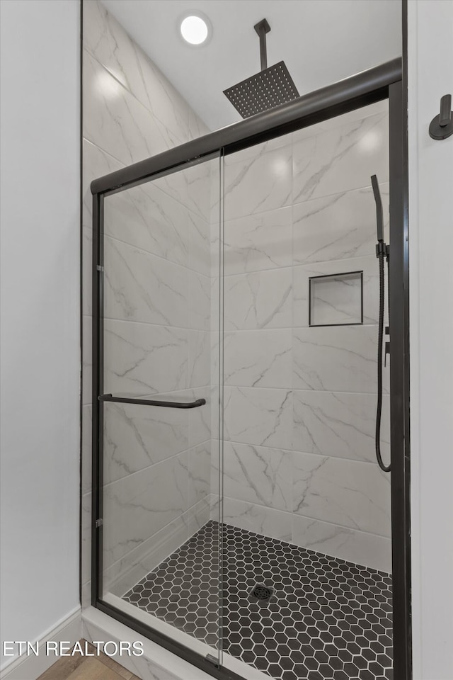 bathroom with a shower with shower door