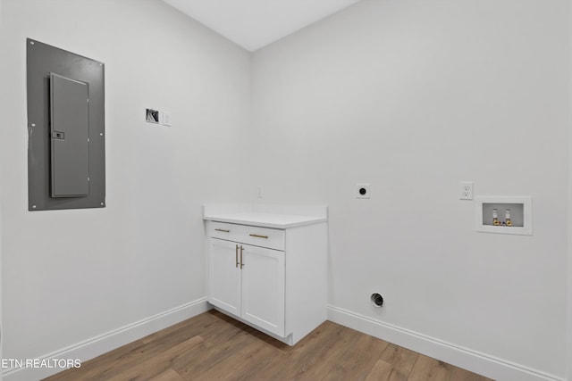 clothes washing area featuring electric dryer hookup, electric panel, light hardwood / wood-style floors, and washer hookup