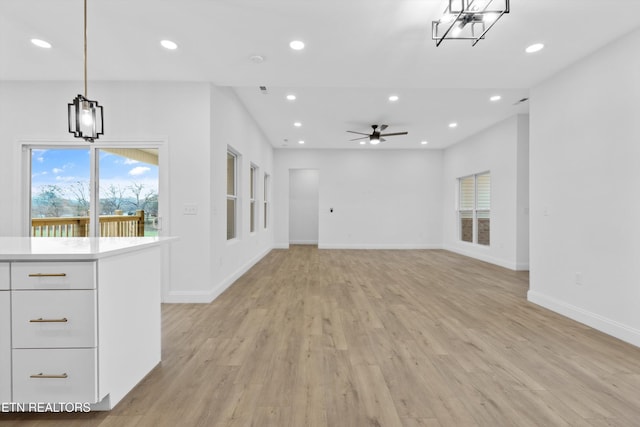 unfurnished living room with ceiling fan and light hardwood / wood-style flooring