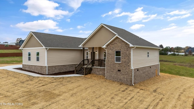 view of front of house with a front yard and a porch