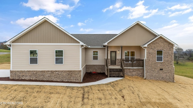 craftsman-style home with a porch and a front lawn