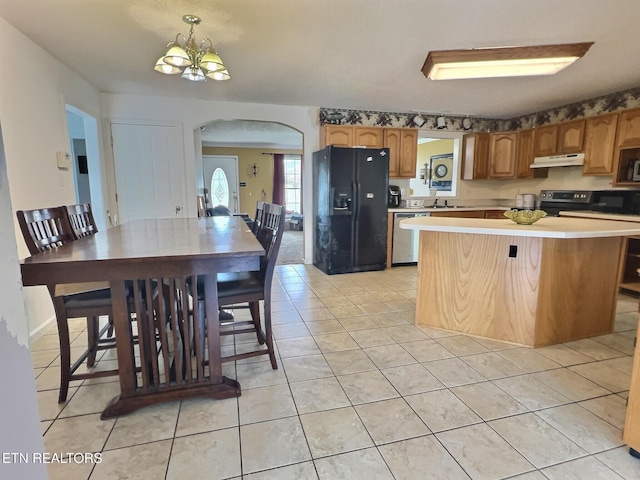 kitchen featuring sink, hanging light fixtures, light tile patterned floors, stainless steel appliances, and a chandelier