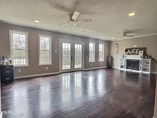 unfurnished living room featuring ceiling fan, french doors, dark wood-type flooring, and ornamental molding