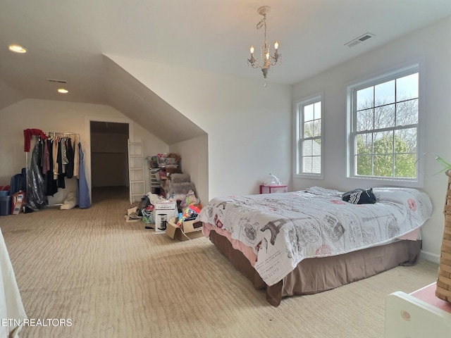 carpeted bedroom featuring a chandelier and vaulted ceiling