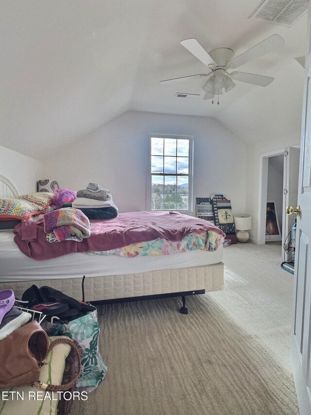 bedroom with ceiling fan, lofted ceiling, and light carpet