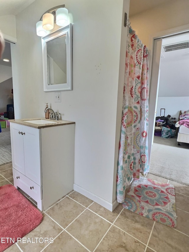 bathroom featuring a shower with shower curtain, vanity, and tile patterned floors