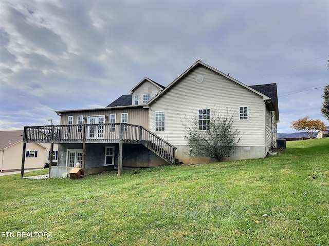 back of property with a yard, cooling unit, and a wooden deck