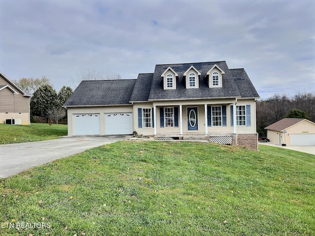 cape cod-style house with covered porch, a garage, and a front yard