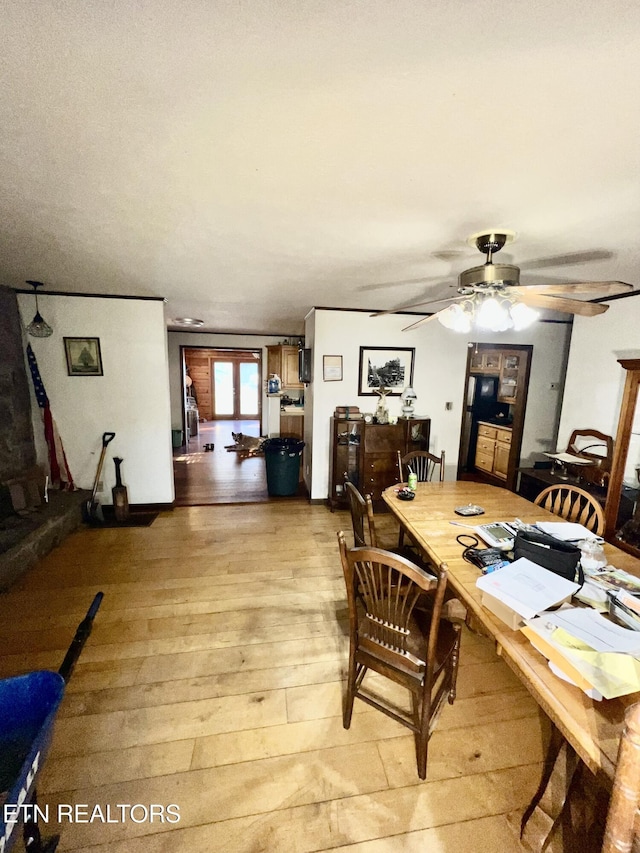 dining space with light wood-type flooring and ceiling fan